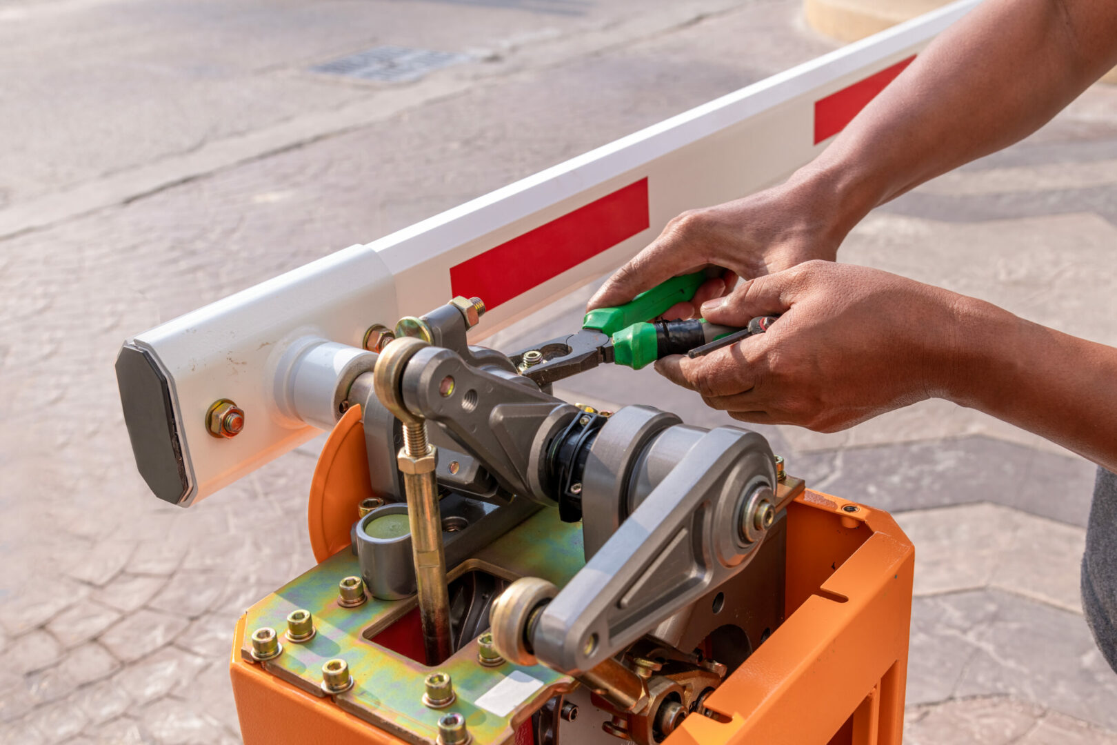 Technician assembling an automatic barrier gate, illustrating advanced automation and robust security features for residential and commercial properties.